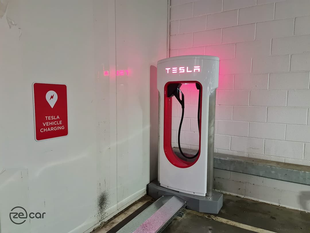 Toombul Tesla Supercharger stall with Tesla Vehicle Charging sign on the wall Toombul Tesla Supercharger stall with Tesla Vehicle Charging sign on the wall