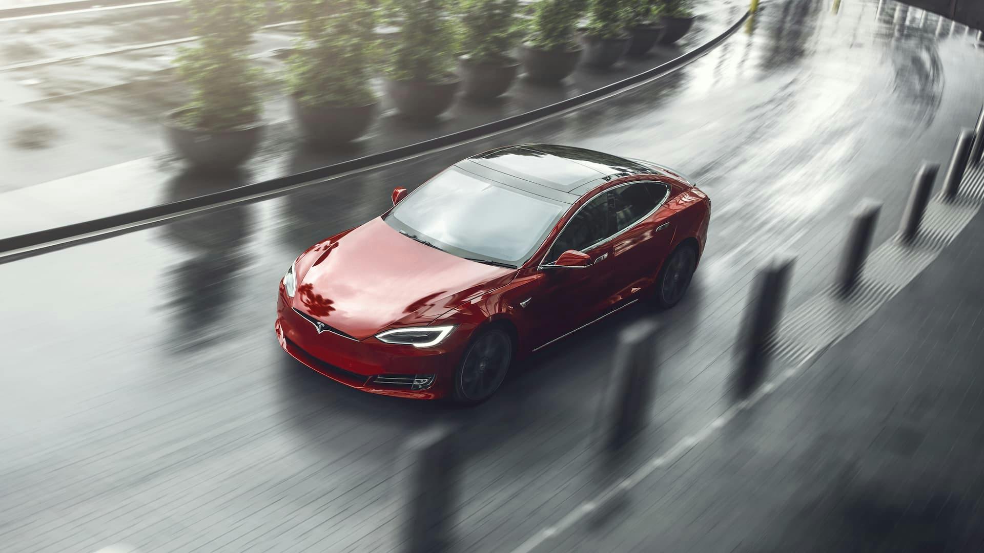 Red Tesla Model S driving