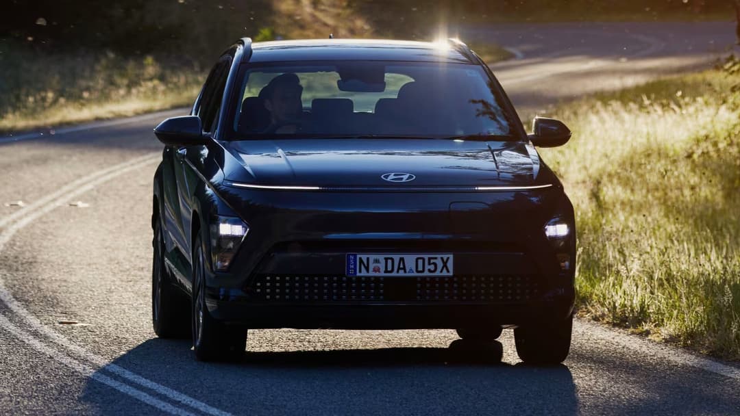 Hyundai Kona driving front view with high contrast lighting Hyundai Kona driving front view with high contrast lighting