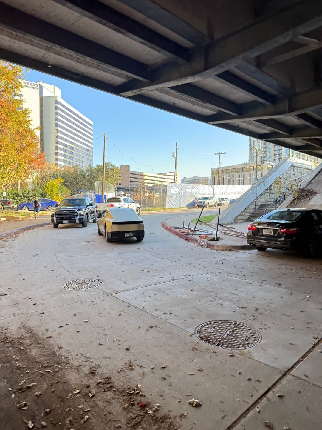 Close-up view of Tesla Cybercab with gold exterior driving on public streets in Texas Close-up view of Tesla Cybercab with gold exterior driving on public streets in Texas