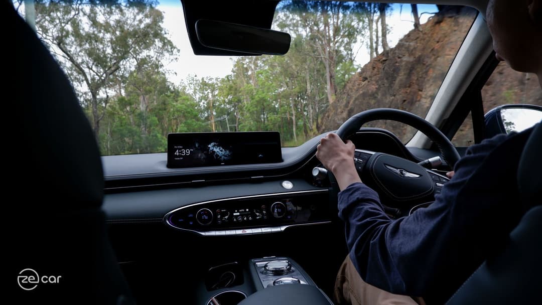 Genesis Electrified GV70 front and interior driving at mountain