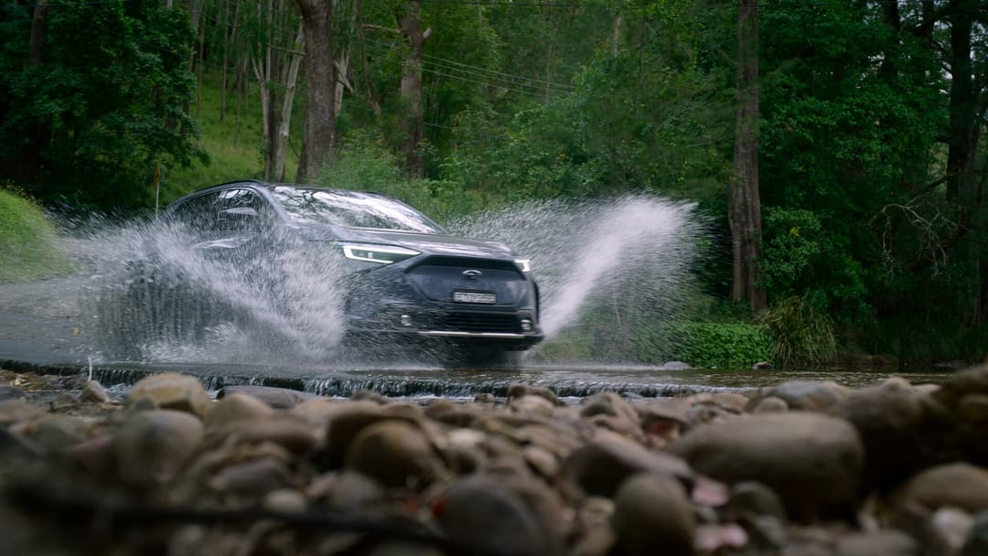 2024 Subaru Solterra driving over stream 2024 Subaru Solterra driving over stream