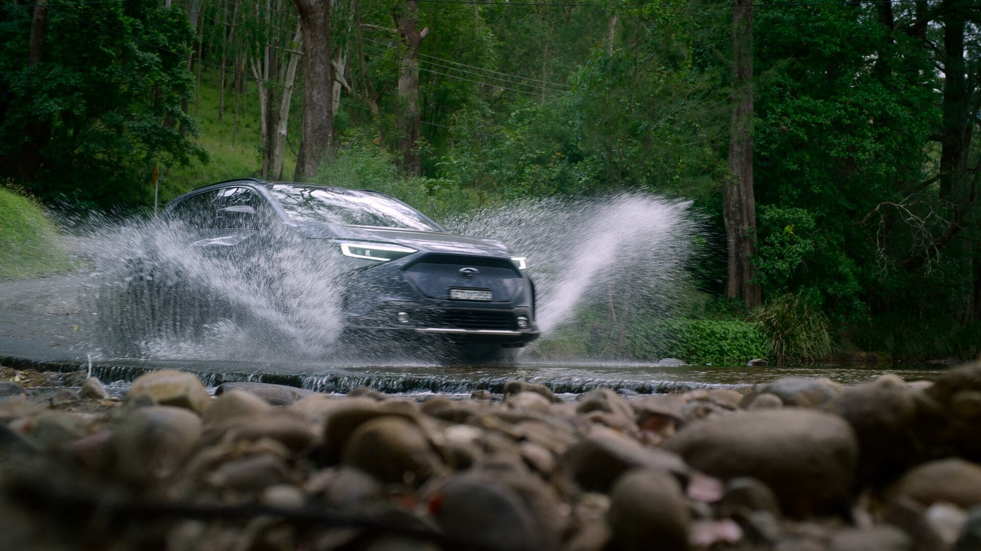 2024 Subaru Solterra driving over stream 2024 Subaru Solterra driving over stream
