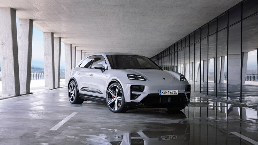 Porsche Macan in white three quarter view parked inside building Porsche Macan in white three quarter view parked inside building