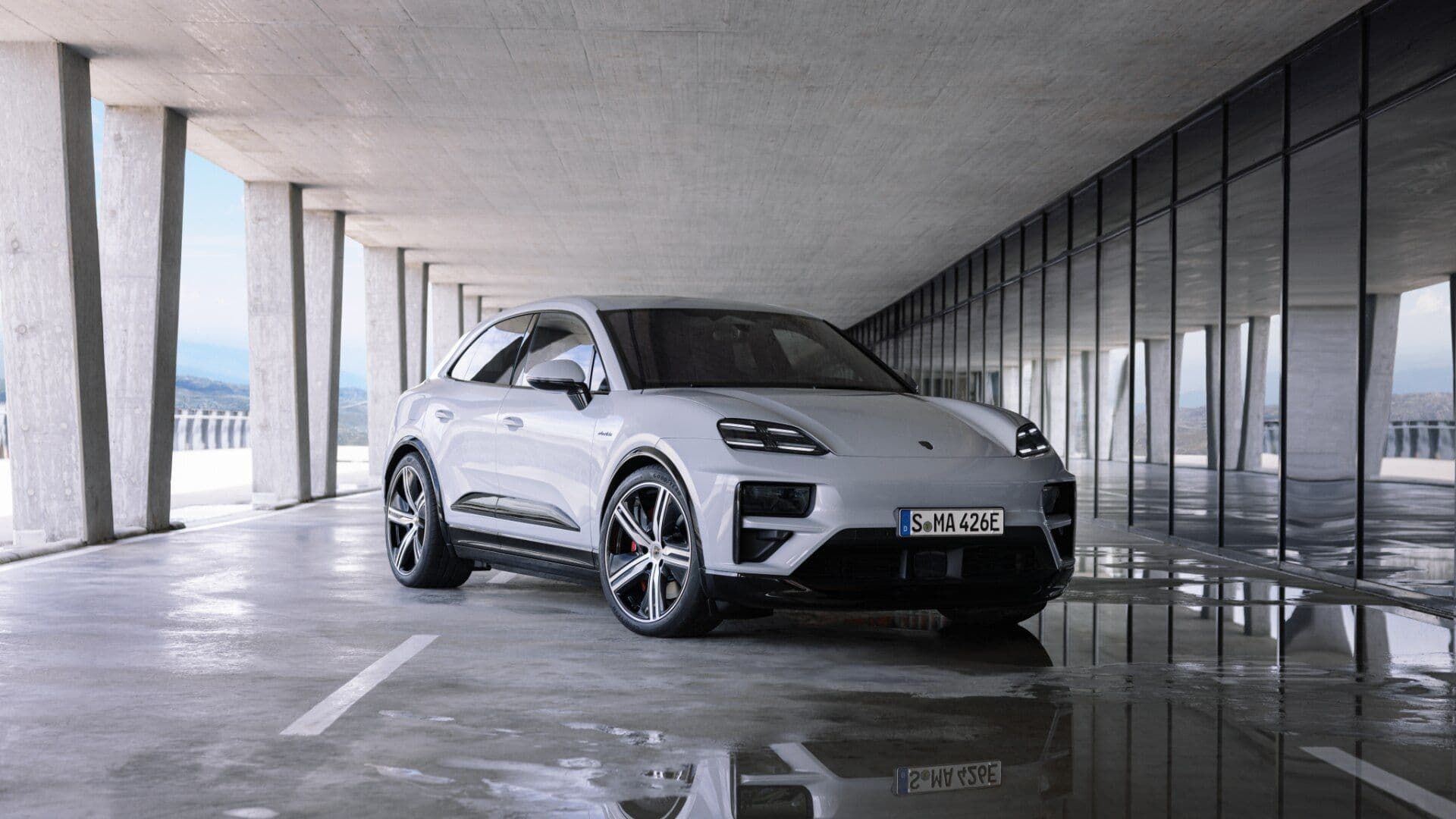 Porsche Macan in white three quarter view parked inside building Porsche Macan in white three quarter view parked inside building