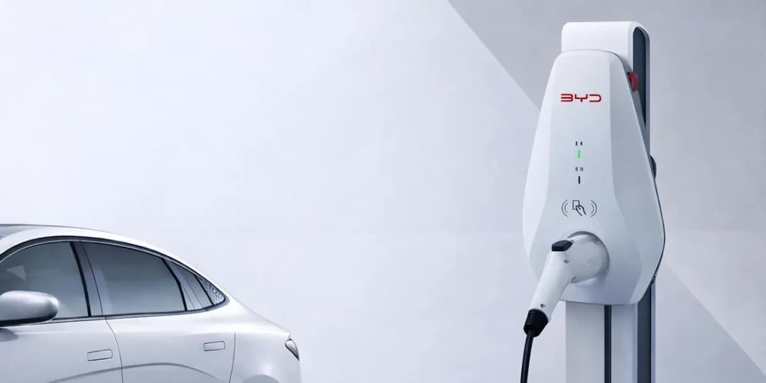 BYD electric vehicle connected to a home charging station with smartphone app displaying sharing options BYD electric vehicle connected to a home charging station with smartphone app displaying sharing options