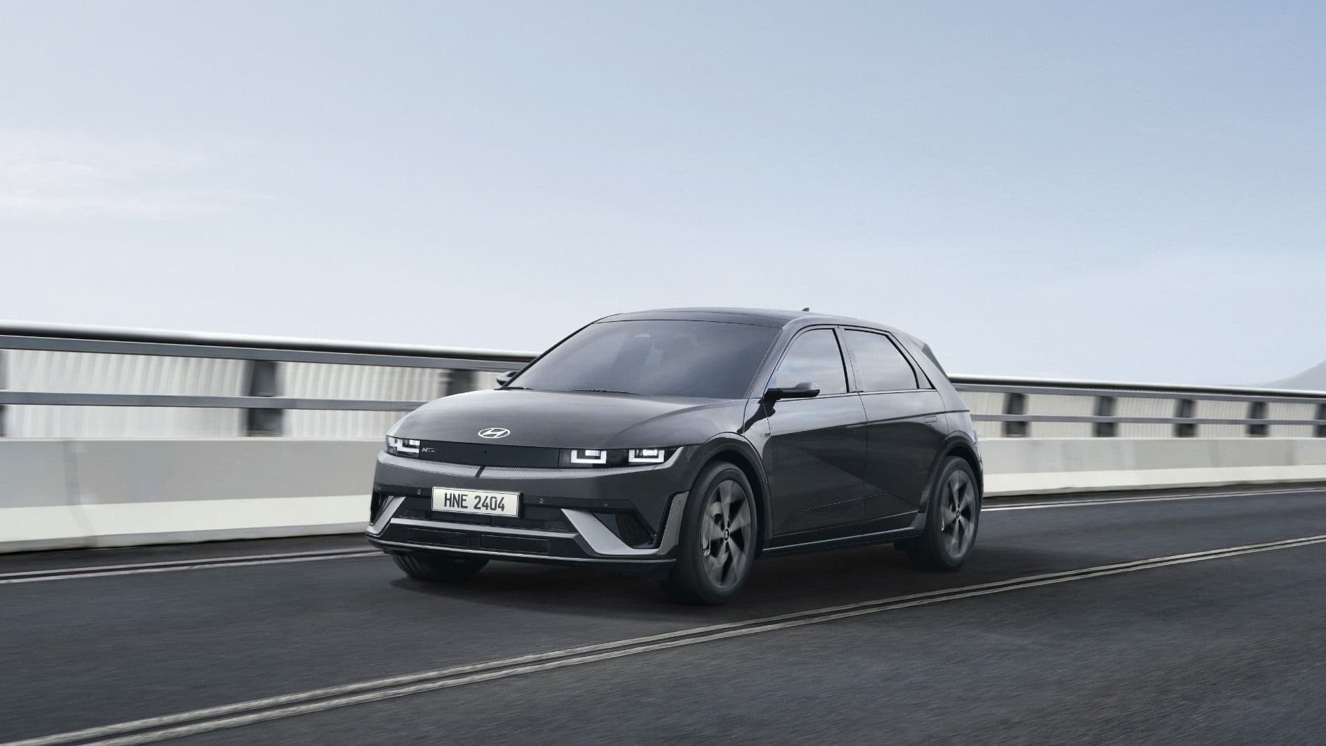 2025 Hyundai Ioniq 5 N Line in black three quarter view driving on road 2025 Hyundai Ioniq 5 N Line in black three quarter view driving on road