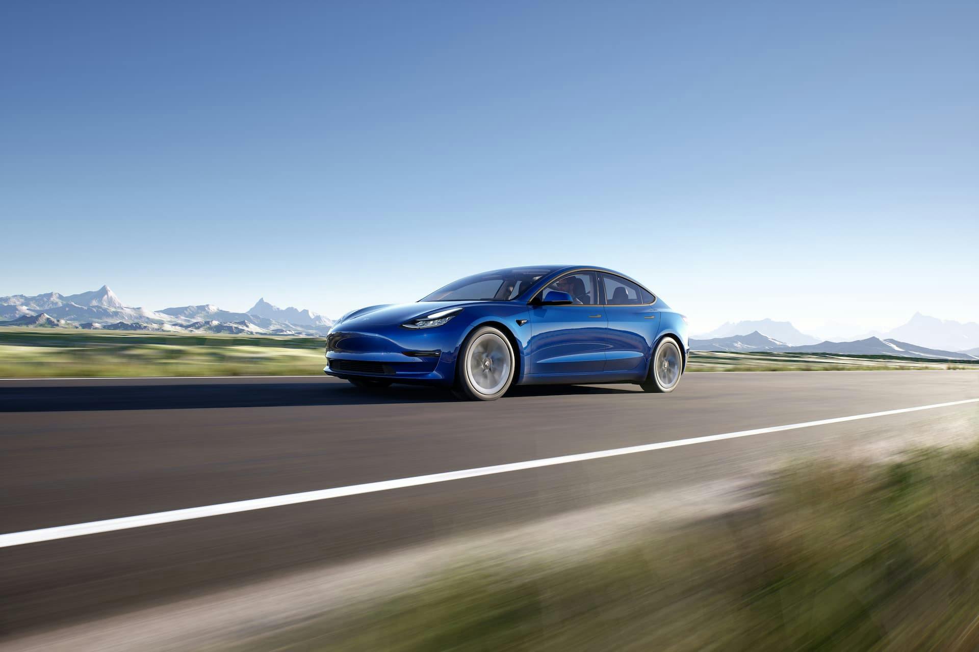 Blue Tesla Model 3 driving