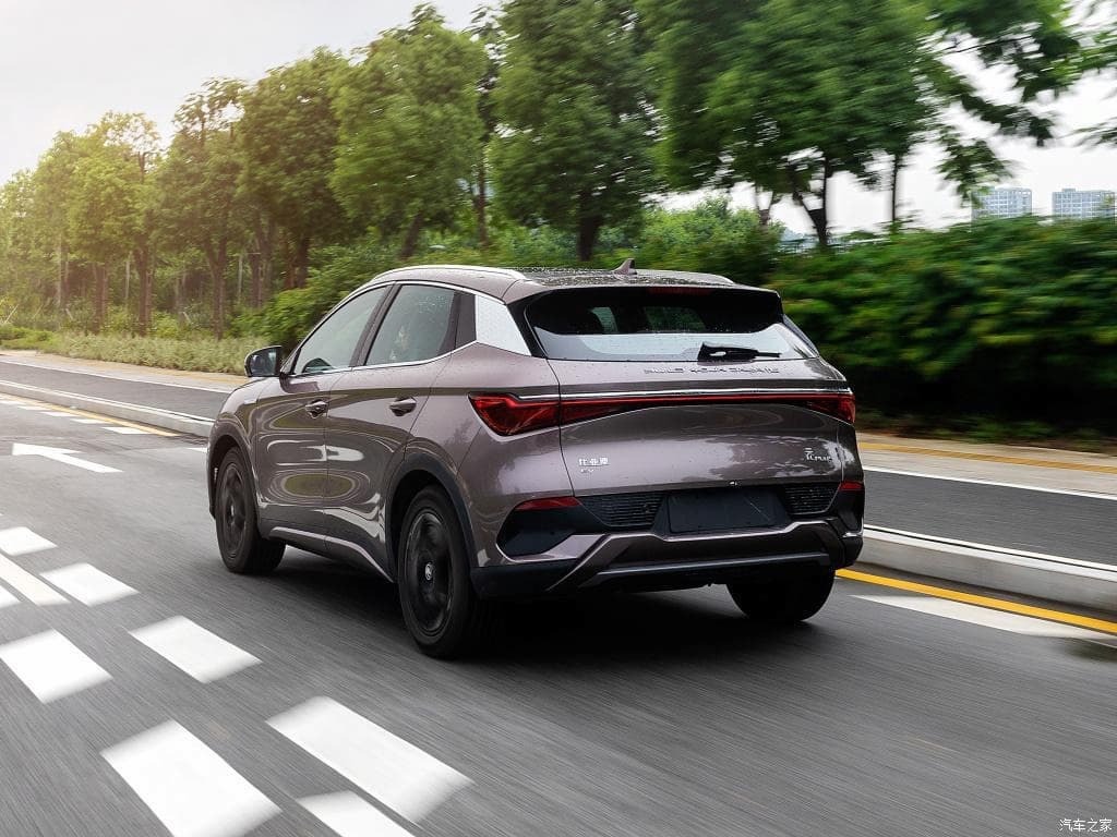 Bronze BYD Yuan Plus SUV driving rear view Bronze BYD Yuan Plus SUV driving rear view