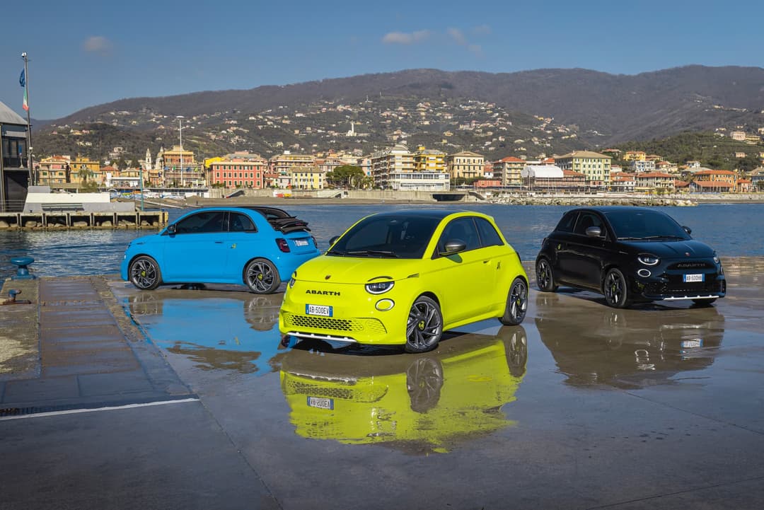Three Abarth 500e EVs on harbour Three Abarth 500e EVs on harbour
