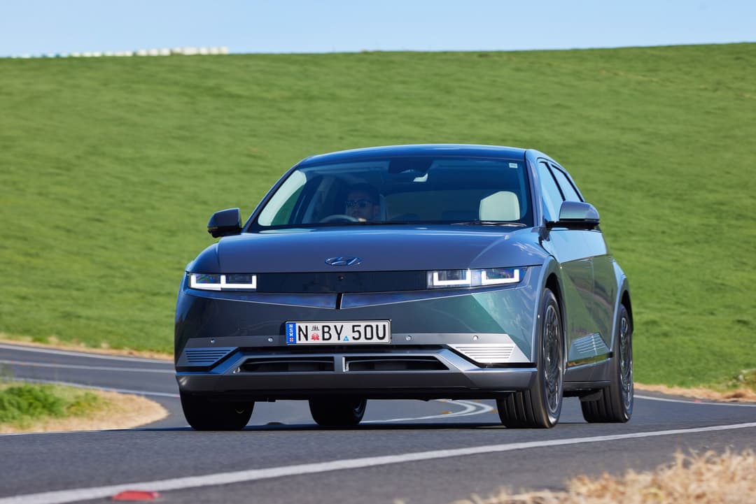 Teal Hyundai Ioniq 5 driving Teal Hyundai Ioniq 5 driving