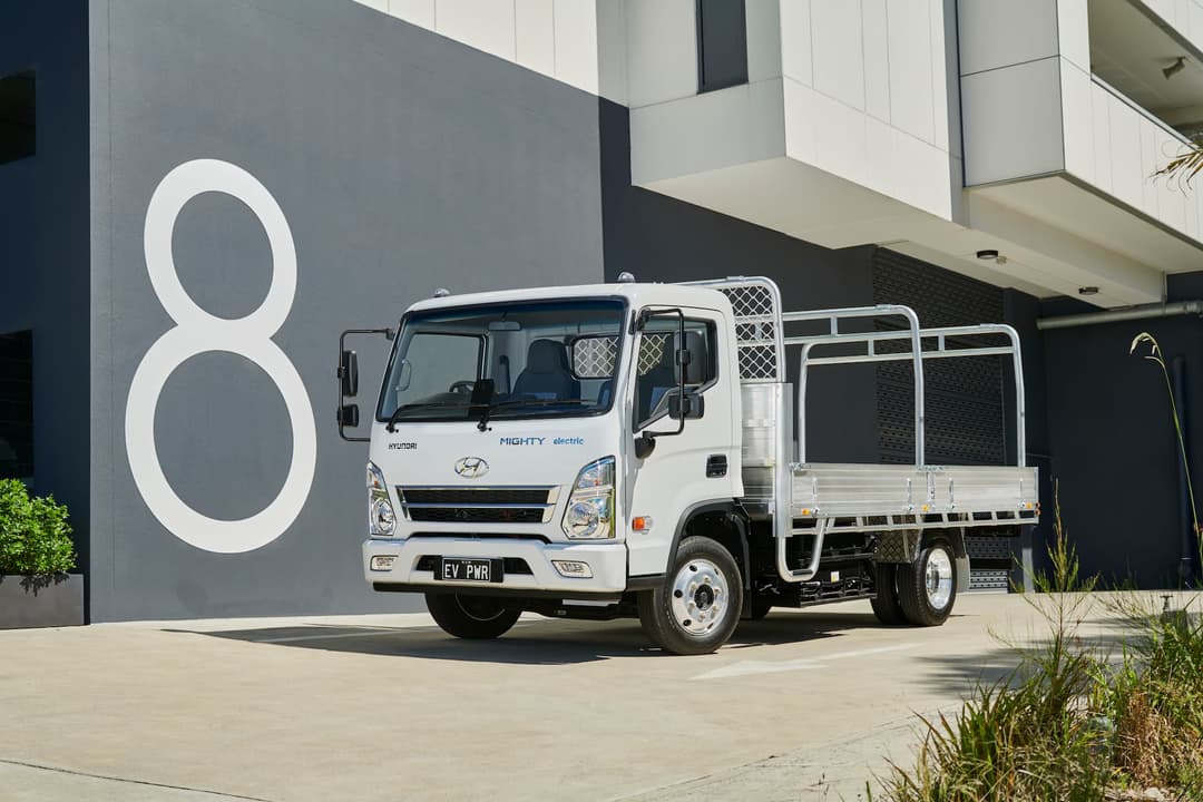 White Hyundai Mighty cab-chassis truck in front of '8' apartment symbol White Hyundai Mighty cab-chassis truck in front of '8' apartment symbol