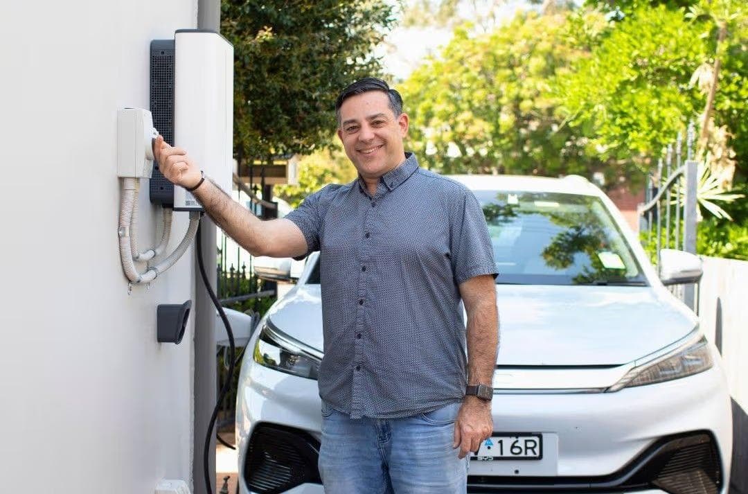 Man with V2G charger and BYD Man with V2G charger and BYD