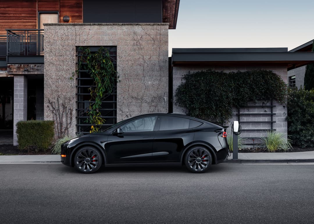 Black Tesla Model Y Performance side view Black Tesla Model Y Performance side view