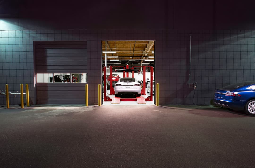 Tesla Model S in servicing workshop at night Tesla Model S in servicing workshop at night