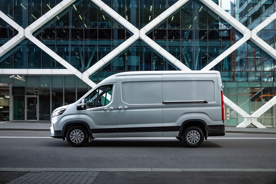 White LDV eDeliver 9 van side view in city White LDV eDeliver 9 van side view in city