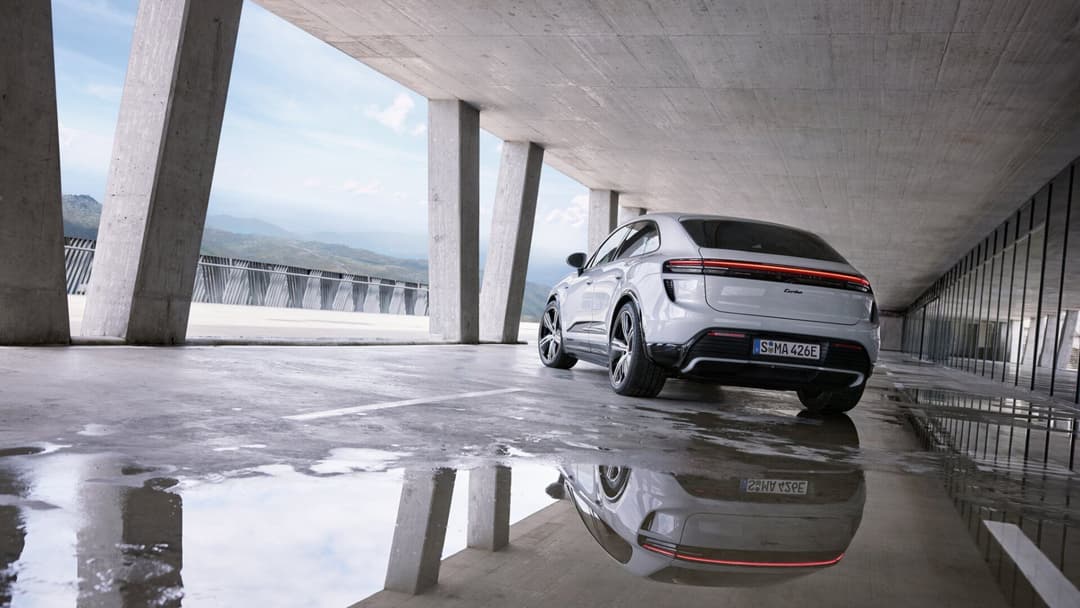 Porsche Macan in white rear view parked inside building Porsche Macan in white rear view parked inside building