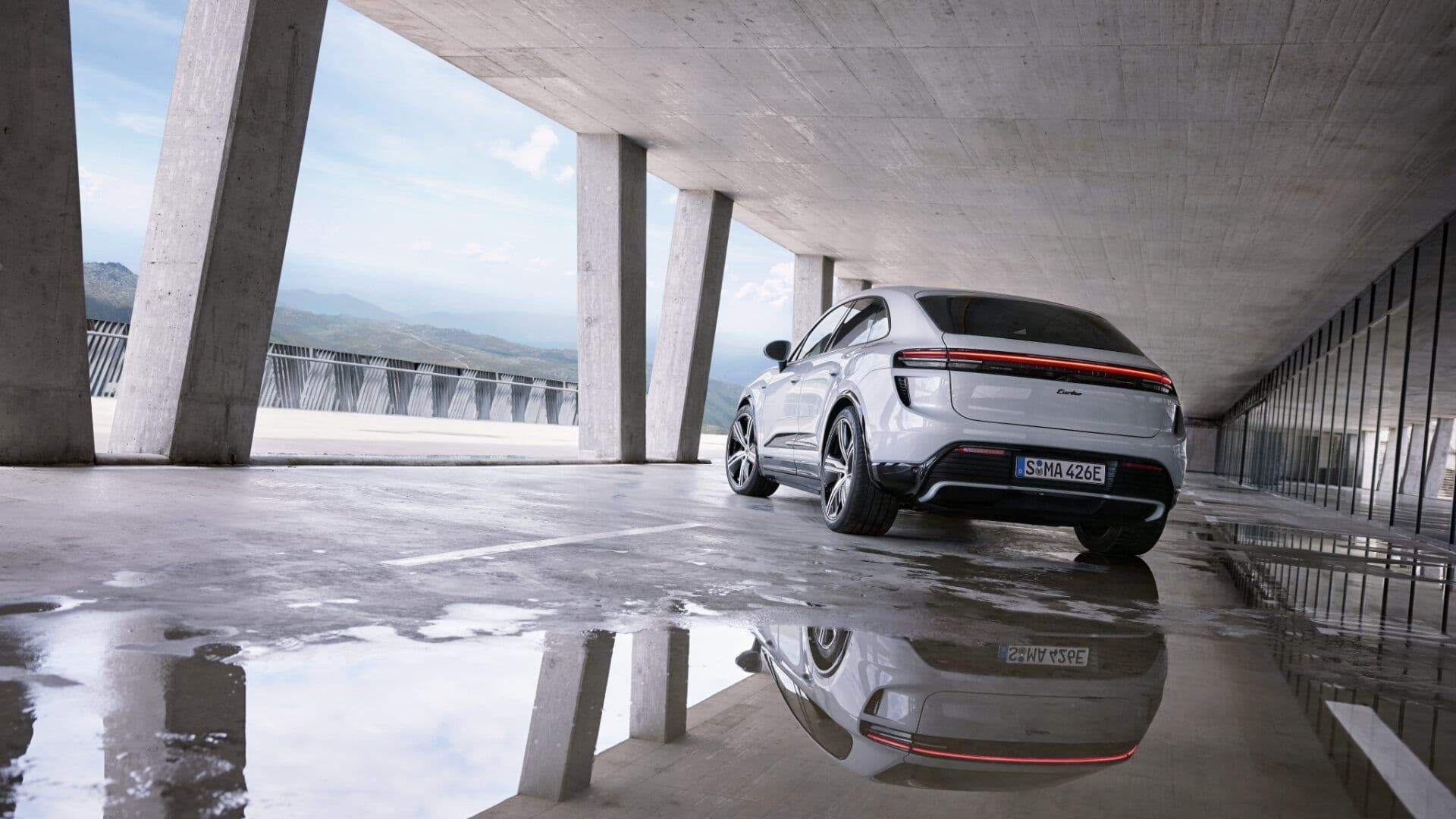 Porsche Macan in white rear view parked inside building Porsche Macan in white rear view parked inside building