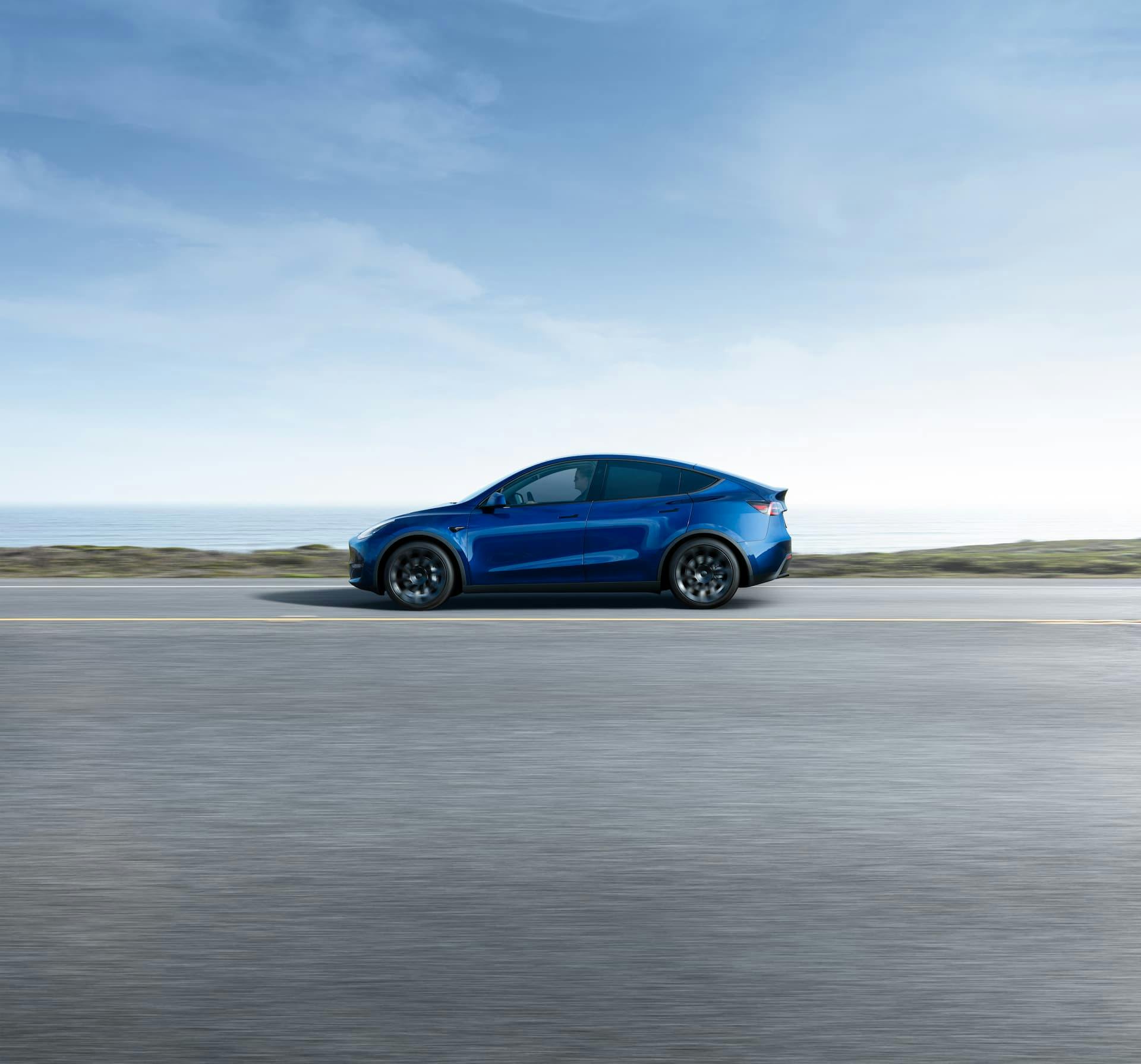 Blue Tesla Model Y driving