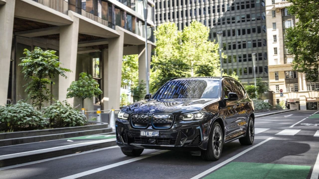2024 BMW iX3 driving at city 2024 BMW iX3 driving at city