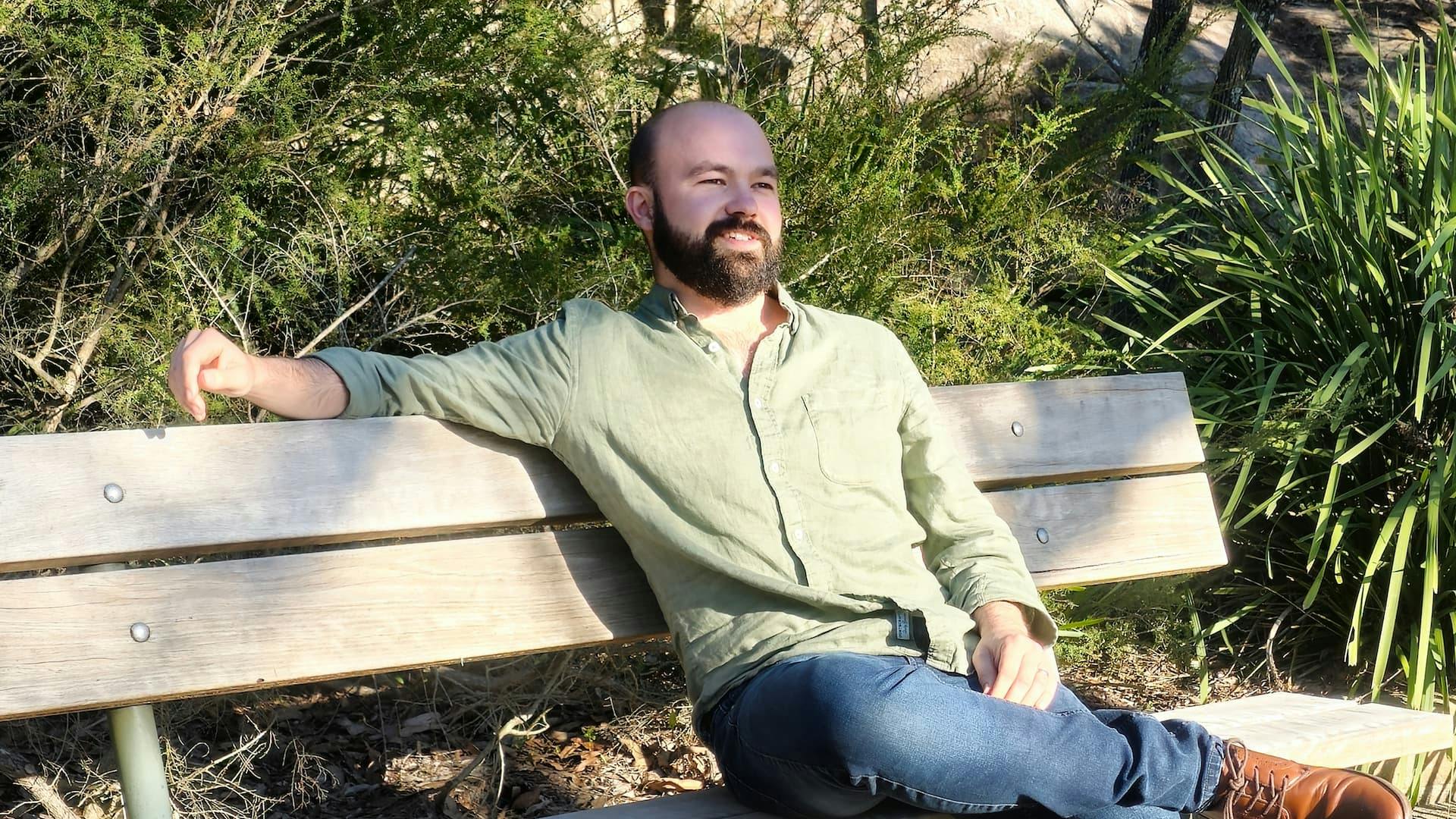 Vyro CEO Will Wise sits on bench in park