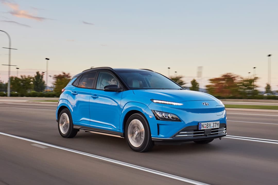 Blue Hyundai Kona Electric driving on highway Blue Hyundai Kona Electric driving on highway