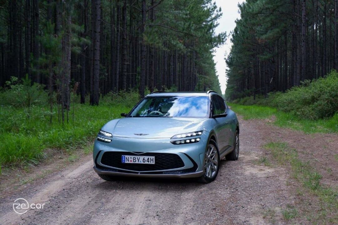 Genesis GV60 AWD fron view in forest trail Genesis GV60 AWD fron view in forest trail