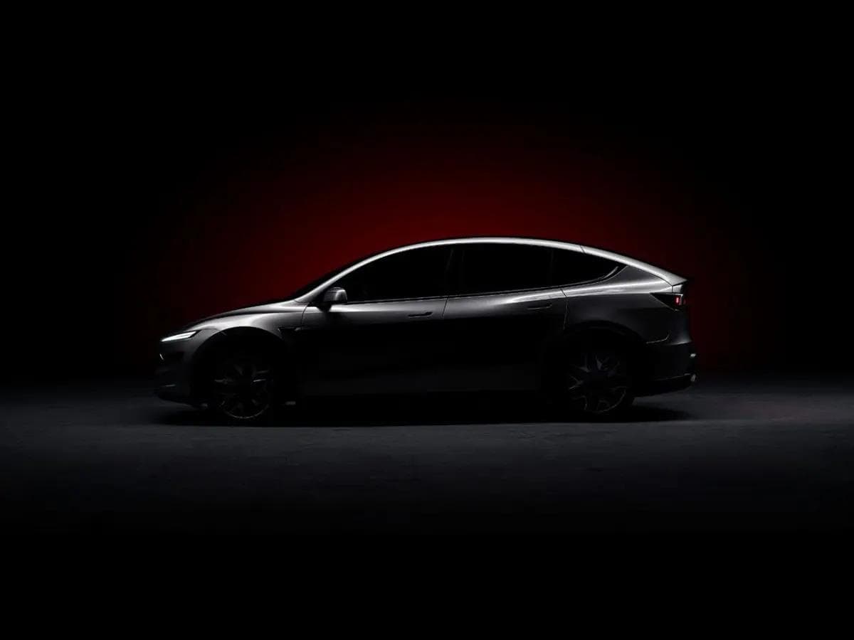 Tesla Model Y Long Range RWD rear three-quarter view displaying sleek design and aerodynamic profile Tesla Model Y Long Range RWD rear three-quarter view displaying sleek design and aerodynamic profile