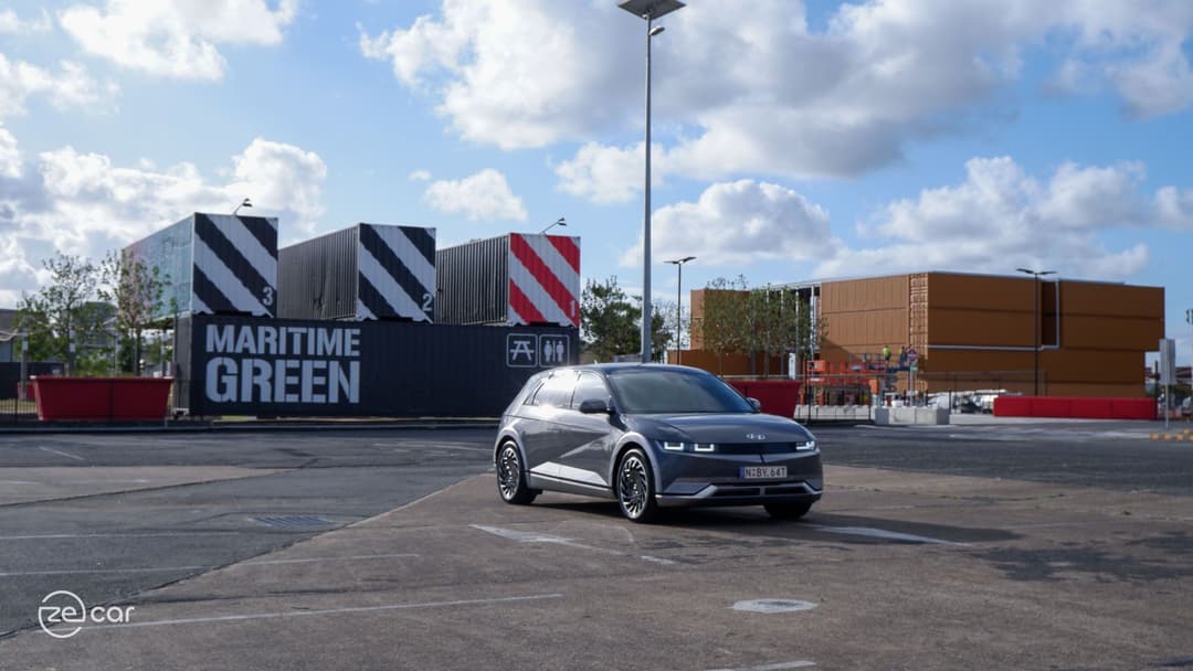 Grey Hyundai Ioniq 5 driving in car park Grey Hyundai Ioniq 5 driving in car park