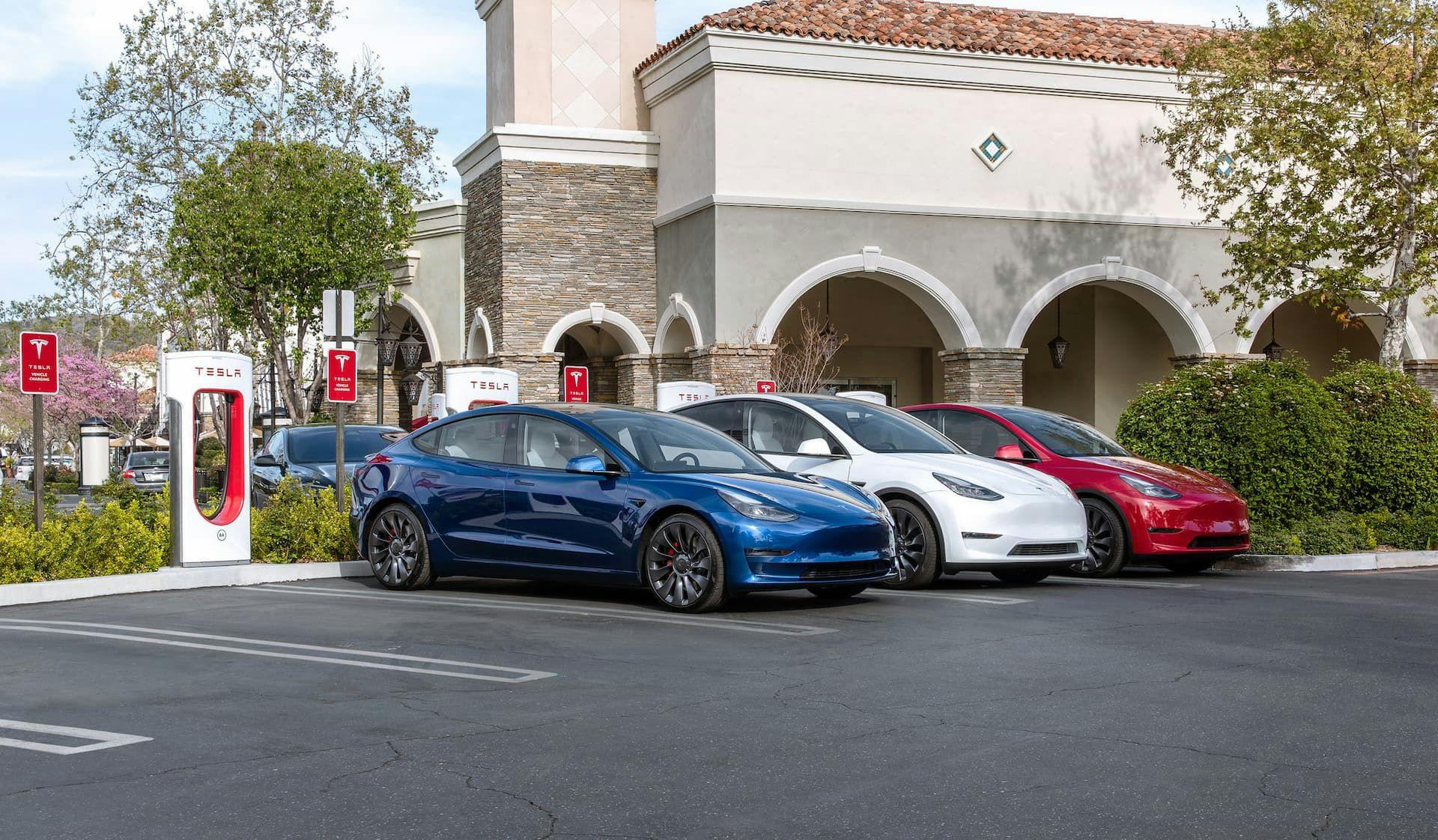 Tesla Model 3 Performance blue Supercharging at carpark