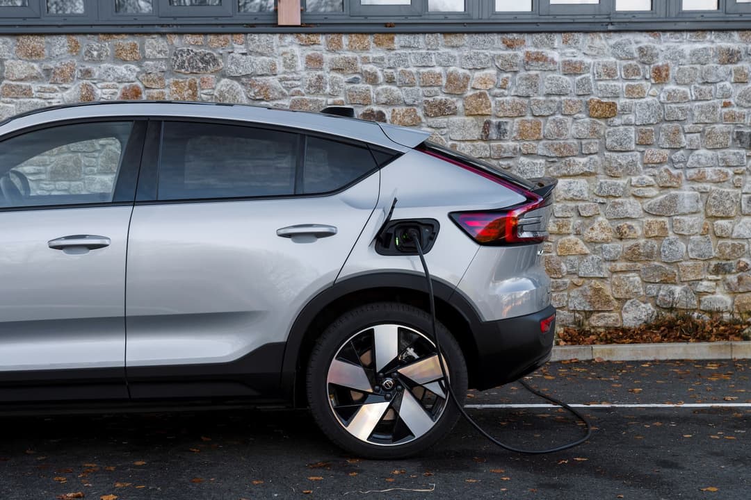 Volvo C40 Recharge with charging plug attached side-rear view Volvo C40 Recharge with charging plug attached side-rear view
