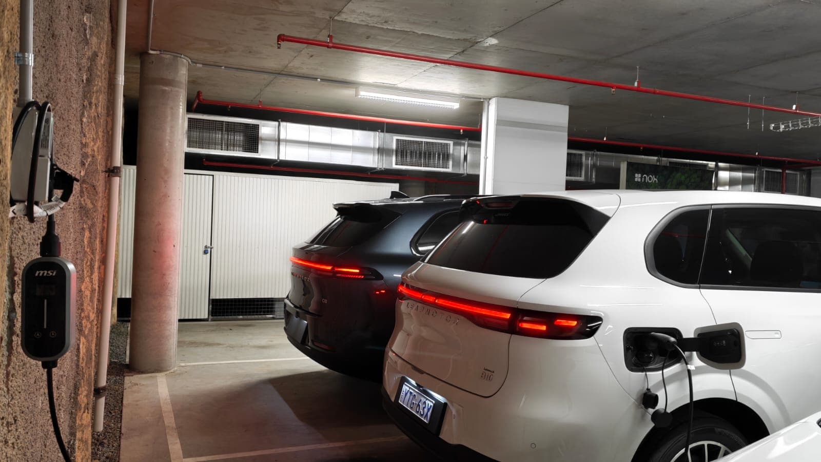 Two Leapmotor EVs charging in the car park at The Griffin apartment building in Canberra Two Leapmotor EVs charging in the car park at The Griffin apartment building in Canberra