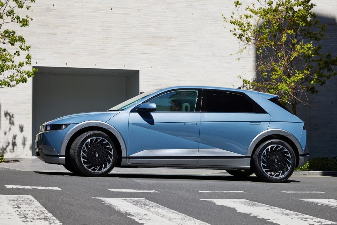 Blue Hyundai Ioniq 5 turning side view Blue Hyundai Ioniq 5 turning side view