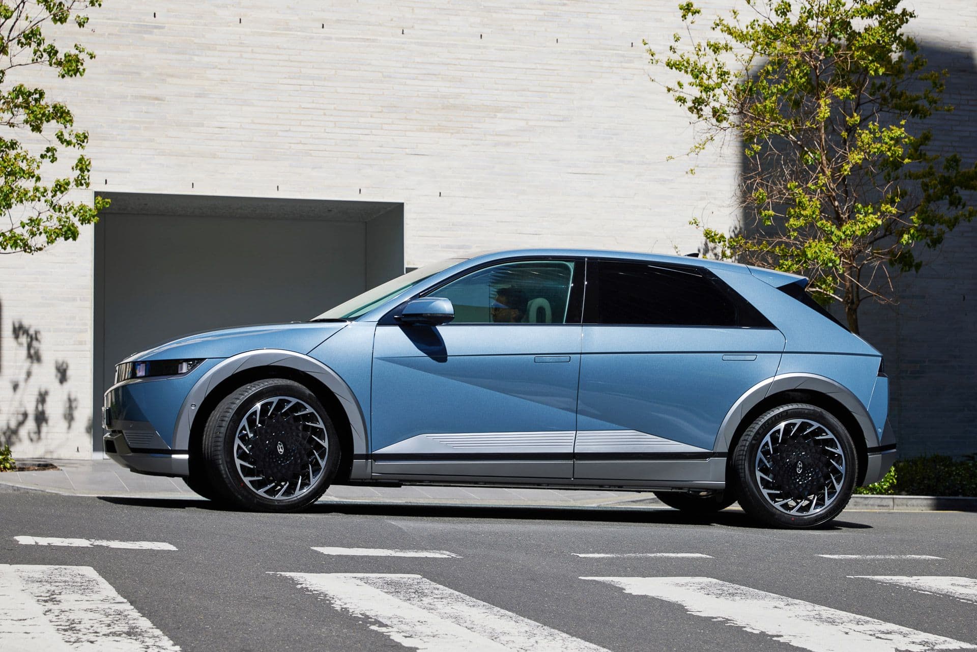 Blue Hyundai Ioniq 5 turning side view Blue Hyundai Ioniq 5 turning side view