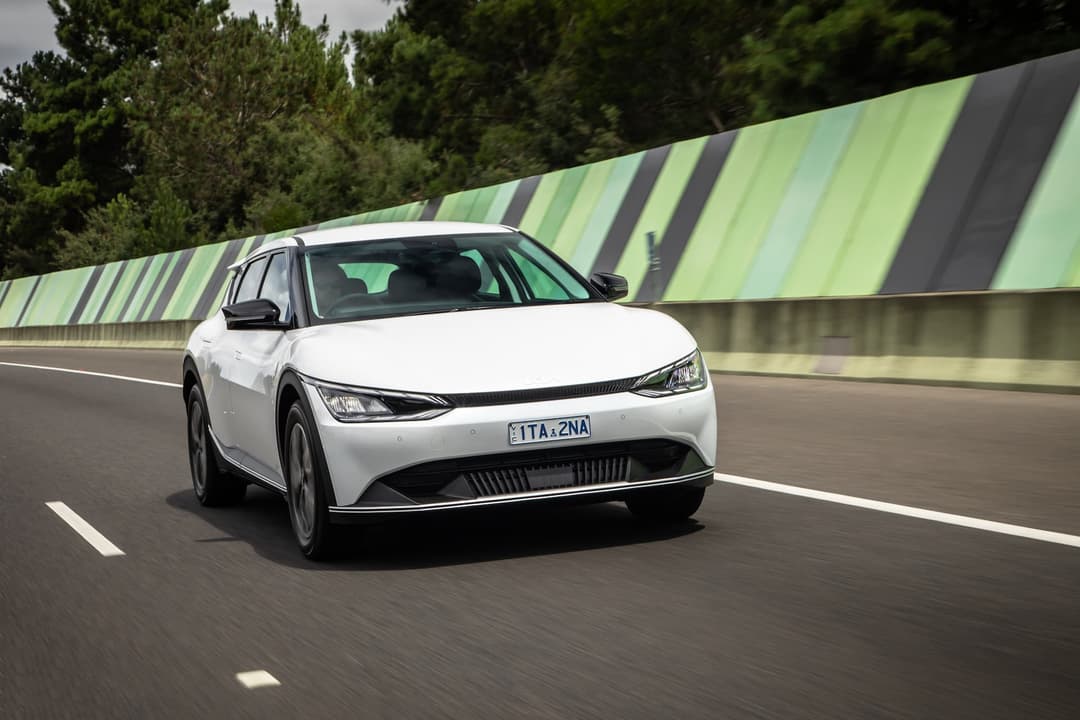 White Kia EV6 Air driving on highway White Kia EV6 Air driving on highway