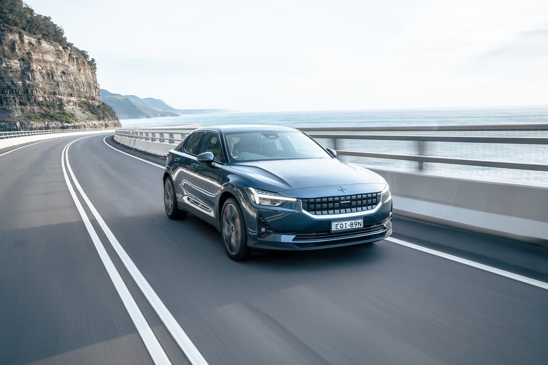 Blue Polestar 2 electric car driving Blue Polestar 2 electric car driving