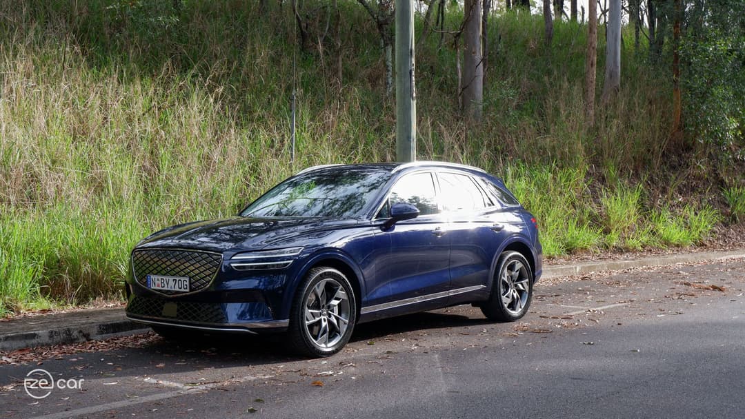 Genesis Electrified GV70 front three-quarter view on mountain scenic drive road sunset Genesis Electrified GV70 front three-quarter view on mountain scenic drive road sunset