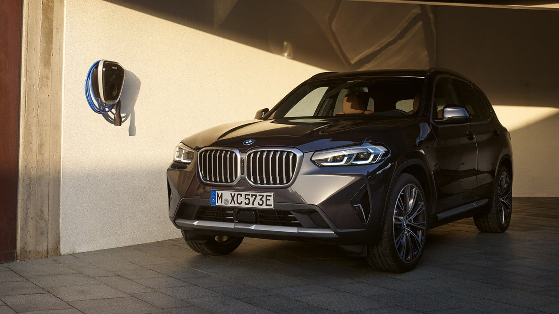 BMW X3 xDrive30e in grey parked three quarter view BMW X3 xDrive30e in grey parked three quarter view