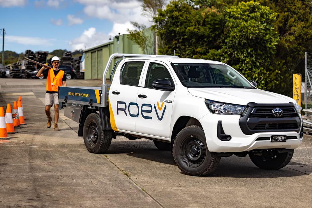 Tradie walks up to ROEV Toyota HiLux EV ute Tradie walks up to ROEV Toyota HiLux EV ute