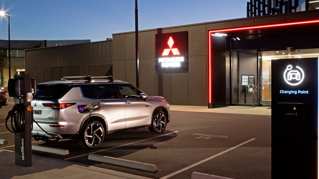 Mitsubishi in grey V2G charging rear quarter view Mitsubishi in grey V2G charging rear quarter view