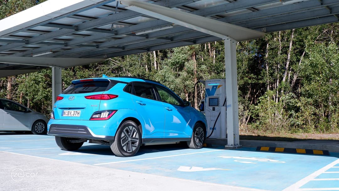 Blue Hyundai Kona Electric charging at 350kW Evie Networks ultra rapid charger Blue Hyundai Kona Electric charging at 350kW Evie Networks ultra rapid charger