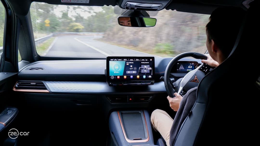 Man driving Cupra Born on scenic drive Man driving Cupra Born on scenic drive