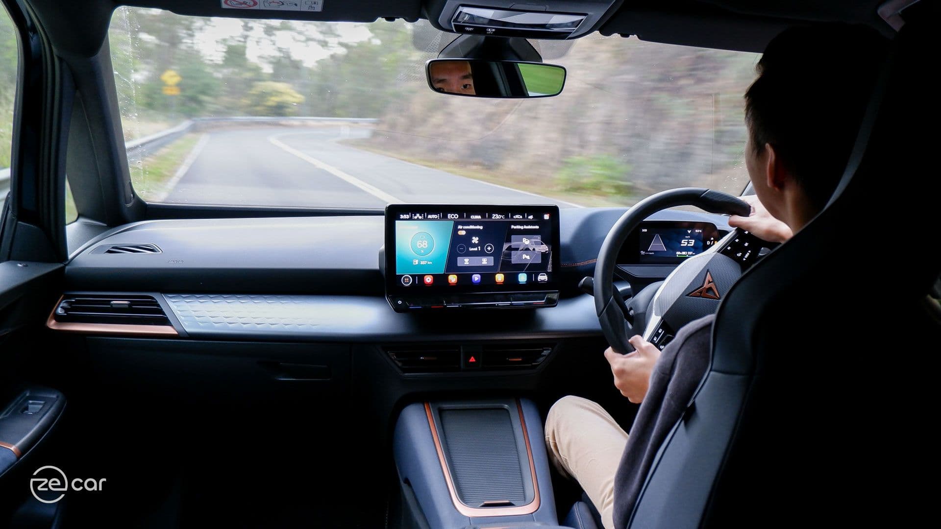 Man driving Cupra Born on scenic drive Man driving Cupra Born on scenic drive