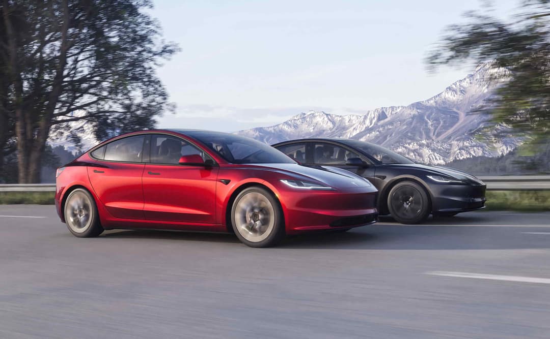 2024 Red Tesla Model 3 driving 2024 Red Tesla Model 3 driving
