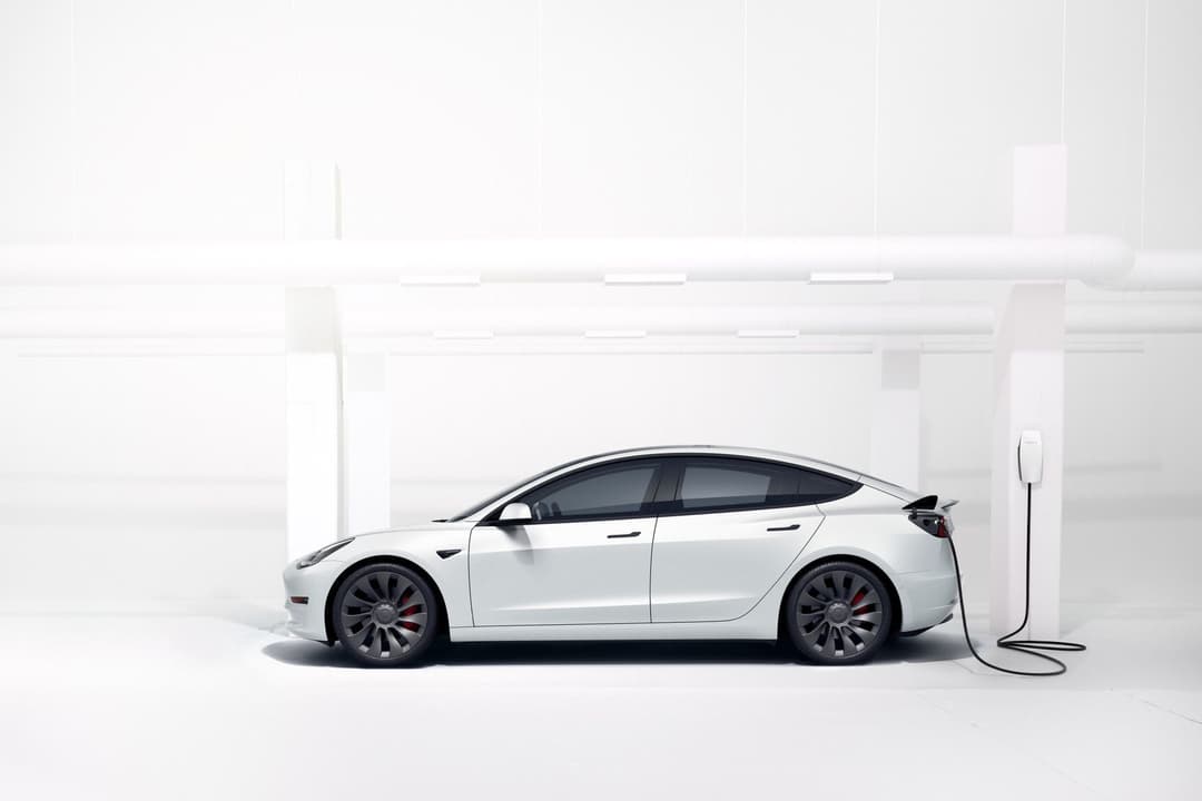 White Tesla Model 3 Performance charging with home wallbox White Tesla Model 3 Performance charging with home wallbox