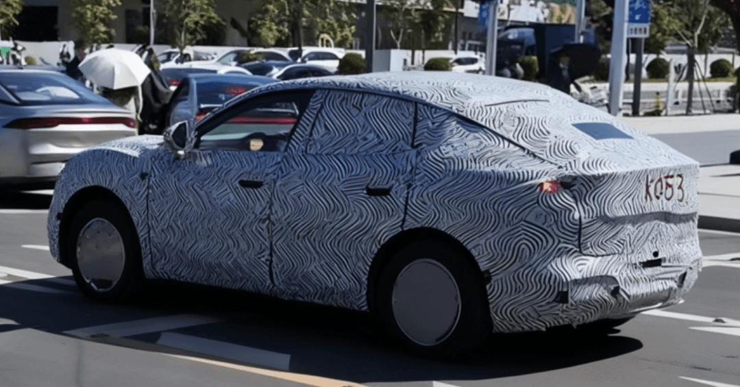 Xpeng Mona SUV camouflaged prototype testing on Chinese roads showing elevated stance and coupe-like profile Xpeng Mona SUV camouflaged prototype testing on Chinese roads showing elevated stance and coupe-like profile