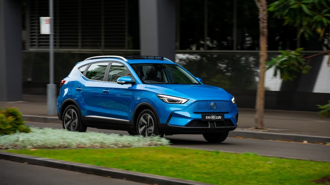 Blue MG ZS EV driving in city Blue MG ZS EV driving in city
