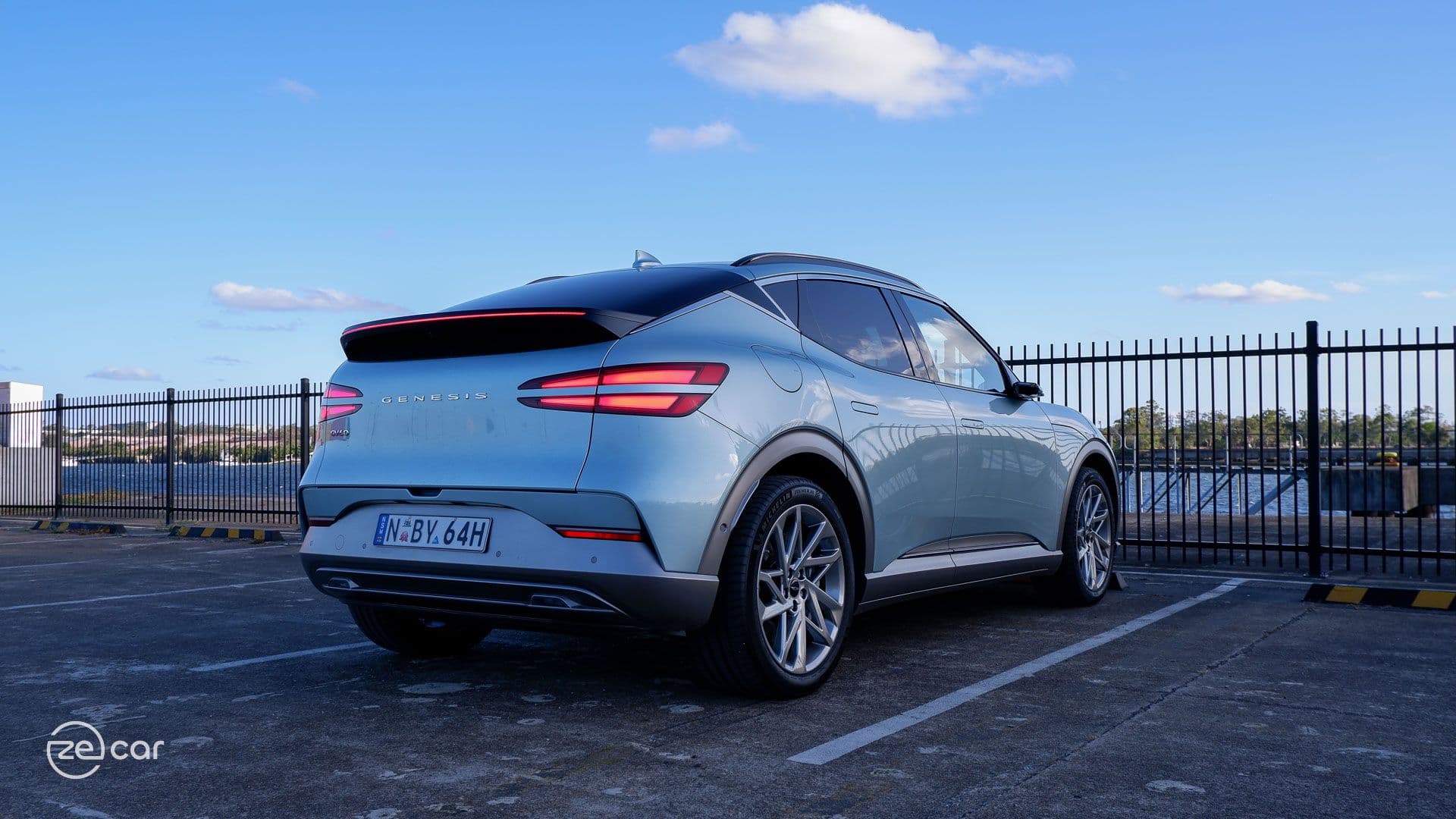 Genesis GV60 AWD in sunset rear with tail lights on Genesis GV60 AWD in sunset rear with tail lights on