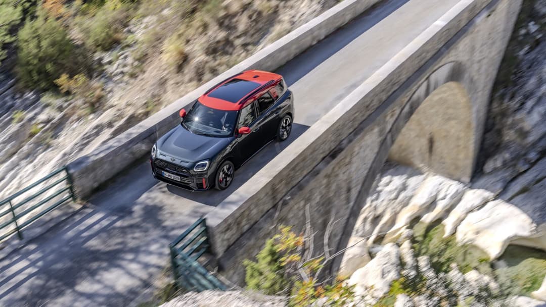MINI Countryman in black crossing a bridge top view MINI Countryman in black crossing a bridge top view