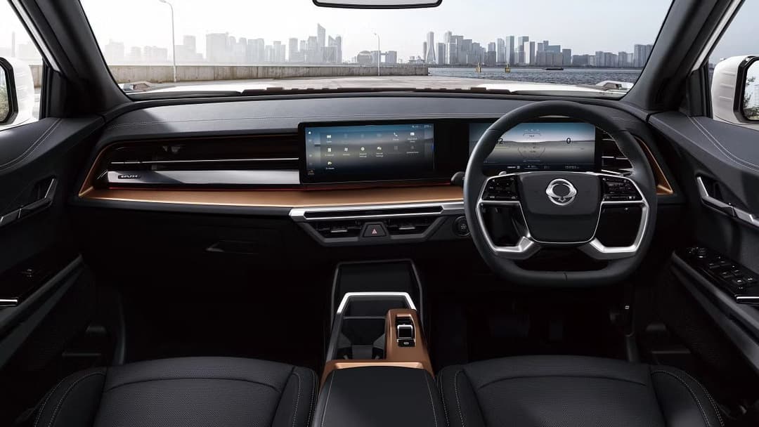 KGM Torres EVX interior dashboard featuring dual 12.3-inch panoramic display screens and premium materials KGM Torres EVX interior dashboard featuring dual 12.3-inch panoramic display screens and premium materials